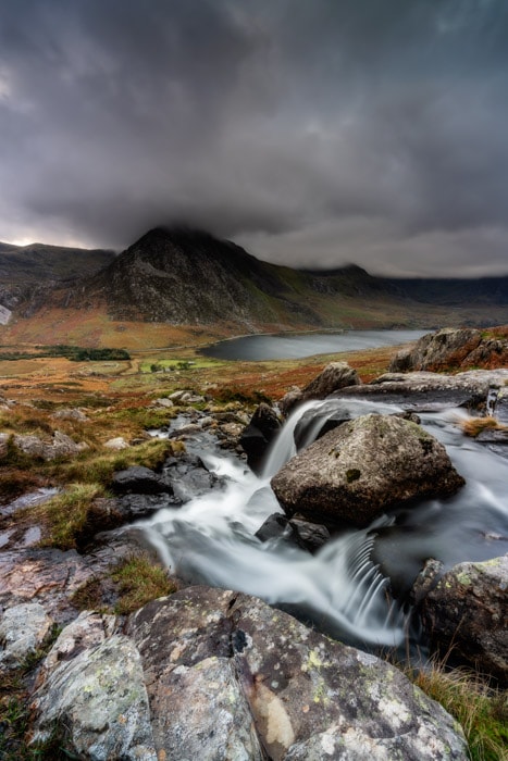 Looking towards Tryfan from Afon Lloer in Snowdonia on a moody autumn evening
